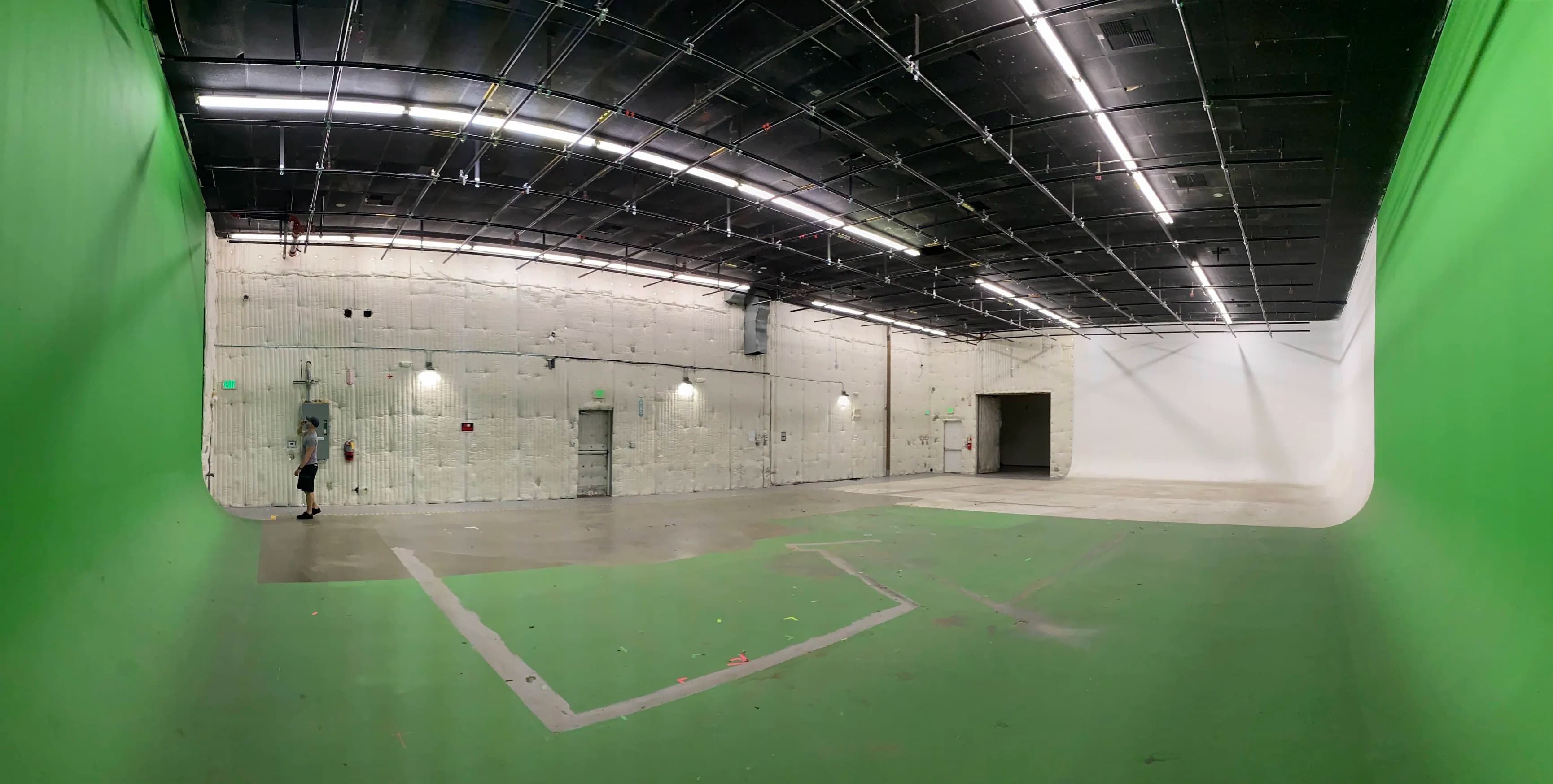 Burbank production stage with white and green surfaces and overhead infrastructure