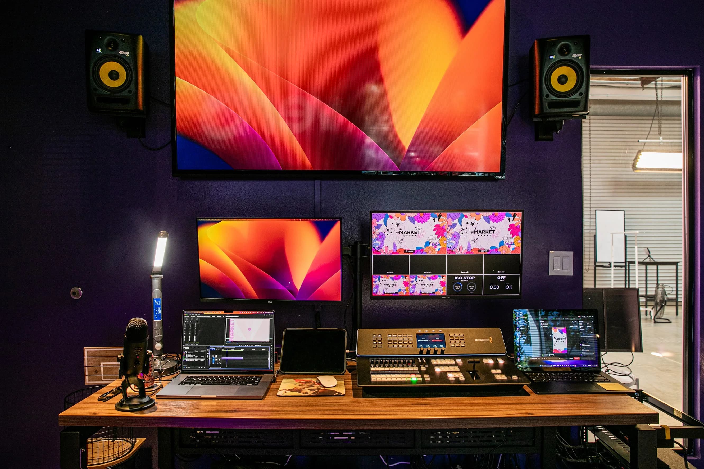 Finished Market.live control room with switcher, audio console, computers, and large monitoring displays