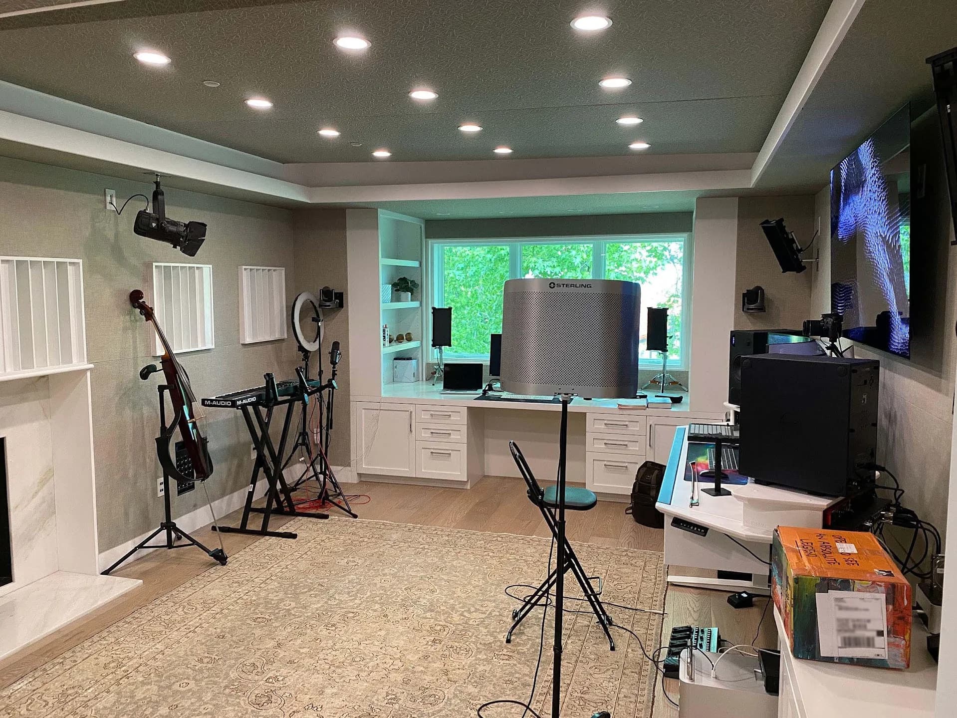Completed Pentatonix home studio with instruments, wall display, recessed lighting, cameras, and production desk