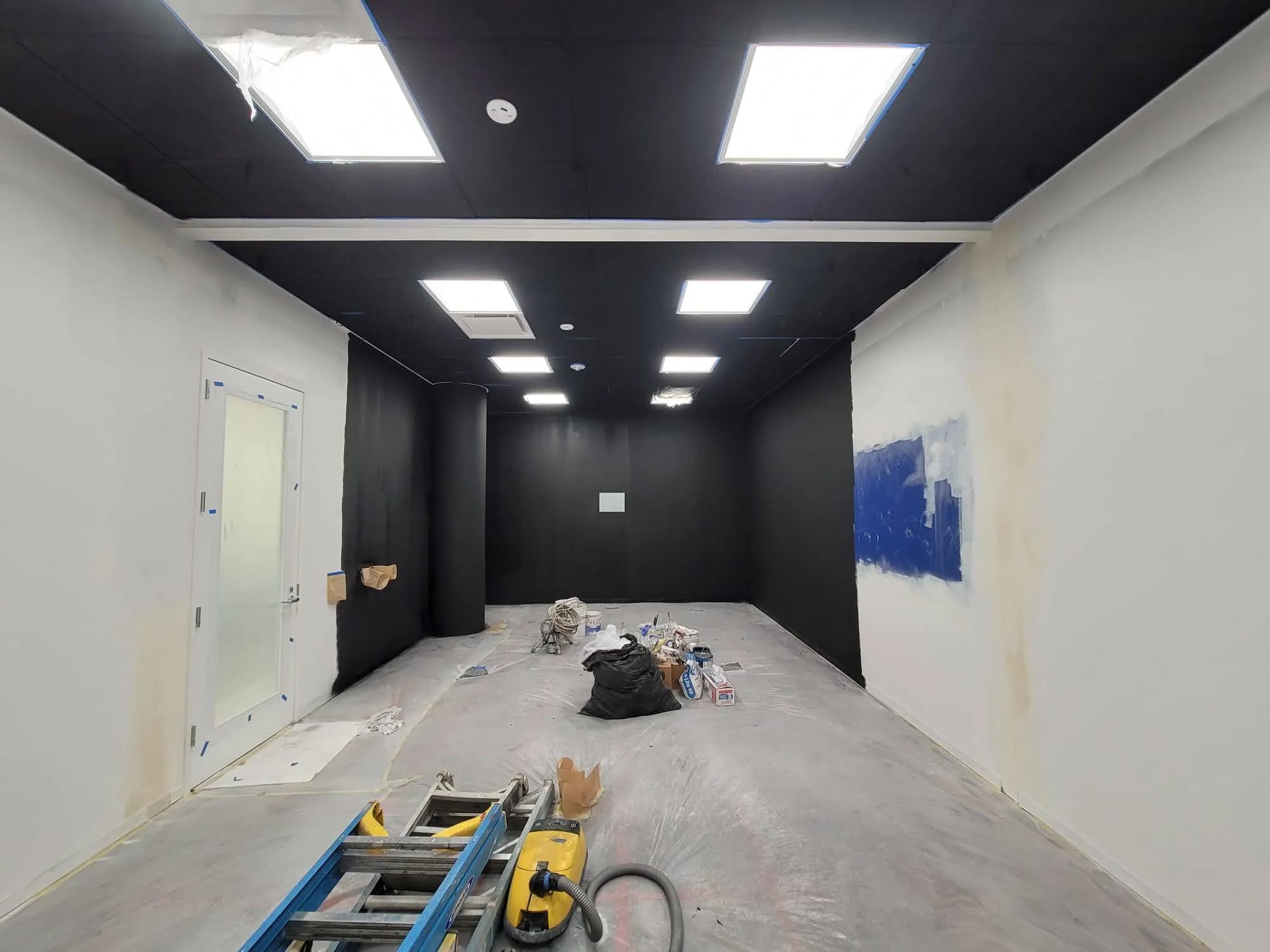 Samsung office conversion with overhead lights and unfinished wall surfaces