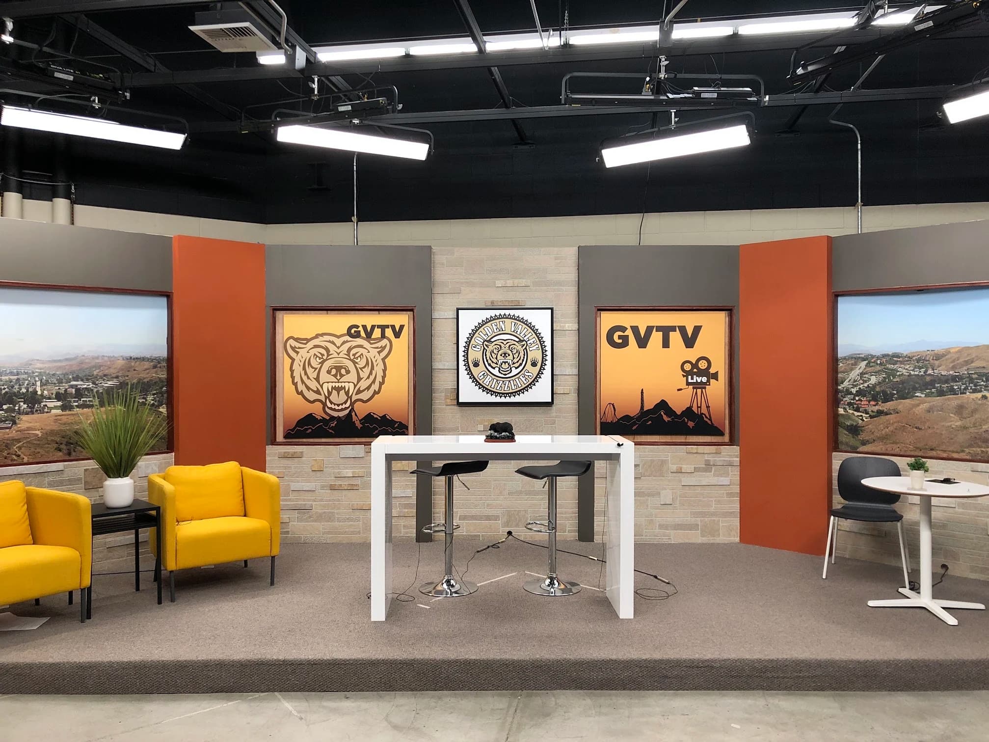 Finished Golden Valley TV studio with multiple presenter areas, displays, scenic panels, and overhead lighting